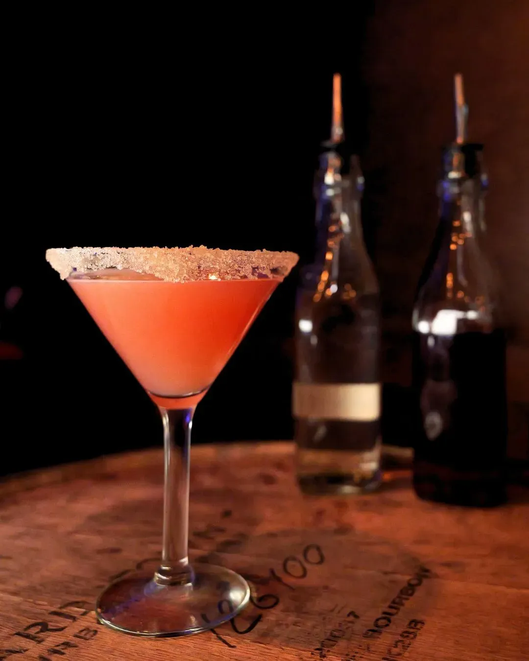 Sugar rimmed martini on bourbon barrel